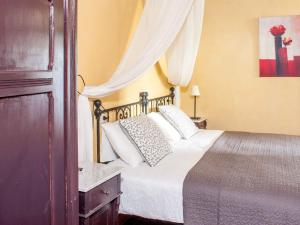 a bedroom with a bed with white sheets and pillows at Il Castello Gavorrano in Gavorrano