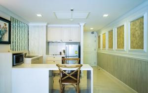 a kitchen with a counter and two chairs in it at Marrakesh Huahin 1 bedroom with pool access 307 in Hua Hin