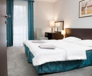 Łóżko lub łóżka w pokoju w obiekcie Apartamenty Aquarius z Aquacenter