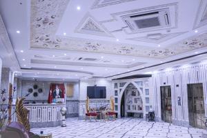 a living room with a coffered ceiling and a table at Al Saif Grand Hotel By Clove International in Muscat