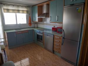 Kuchyň nebo kuchyňský kout v ubytování Apartamento Sanchiz
