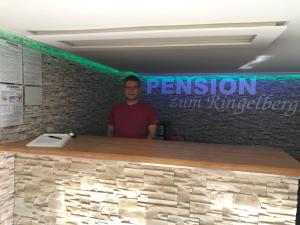 a man standing in front of a stone counter at Pension zum Ringelberg in Erfurt