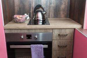 a kitchen with a stove and a tea kettle at ELEVATING MOMENTS in Burgas City