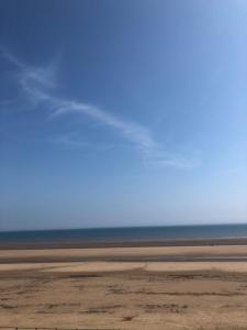 a view of the beach with the ocean in the background at Sandy bay 56 sunrise drive first floor apartment in Filey