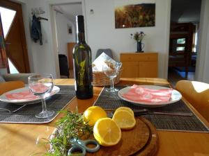 a table with a bottle of wine and plates of food at Zum Rebberg Ferienwohnungen in Freiburg im Breisgau