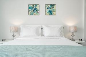 a bedroom with a white bed with two lamps at Santa Luzia I by An Island Apart in Funchal