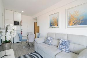 a living room with a couch and a table at Santa Luzia I by An Island Apart in Funchal