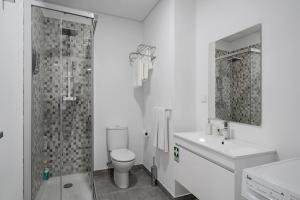 a bathroom with a shower and a toilet and a sink at Santa Luzia I by An Island Apart in Funchal +15 photos