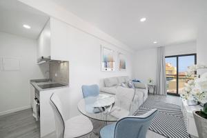 a living room with a couch and a table and chairs at Santa Luzia I by An Island Apart in Funchal