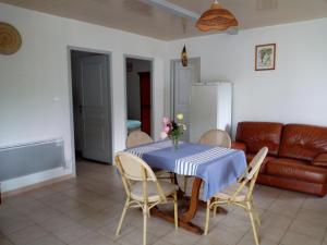 a living room with a table and chairs and a couch at Gîte Etxe Xuri in Ossès