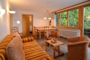 a living room with a couch and a table at Schwarzwaldmädel-Ferienwohnungen in Todtnau +78 photos