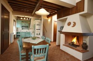 a kitchen and dining room with a table and a fireplace at Castel di Pugna in Siena