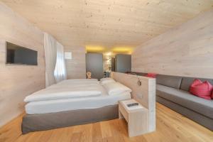 Un pat sau paturi într-o cameră la Garni Tramans
