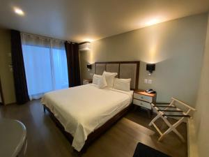 a hotel room with a bed and a desk and a window at Suites Lerma 205 in Mexico City