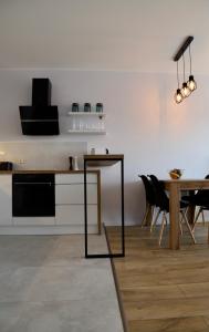 a kitchen with a table and a dining room at Apartament Gdańsk Baltica Towers 7floor in Gdańsk