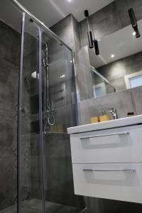 a bathroom with a shower and a sink at Apartament Gdańsk Baltica Towers 7floor in Gdańsk