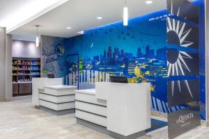 a store with a city mural on the wall at La Quinta Inn & Suites by Wyndham Kansas City Beacon Hill in Kansas City