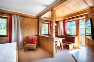 a bedroom with a desk and a table in a room at Gästehaus Stotter in Neukirchen am Großvenediger