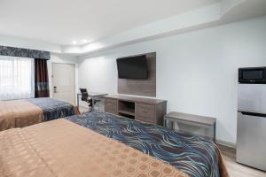 Postel nebo postele na pokoji v ubytování Super 8 by Wyndham Humble Houston Fallcreek