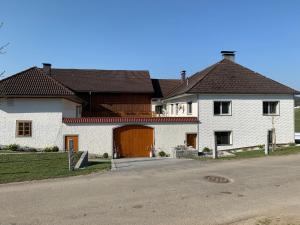 a large white house with a brown door at Ferienwohnung-Mühlviertel in Oepping