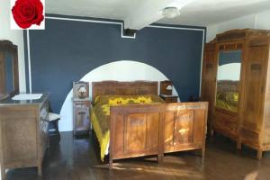 a bedroom with a bed and some wooden cabinets at Casa le Rose in Ameno