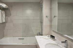 a bathroom with a sink, toilet and bathtub at President Hotel in Athens