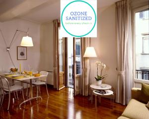 a dining room and living room with a table and chairs at Residence Hilda in Florence