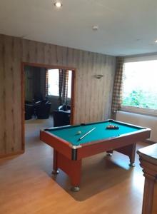 a room with a pool table in a room at Hôtel Akena Le Touquet-Camiers in Camiers
