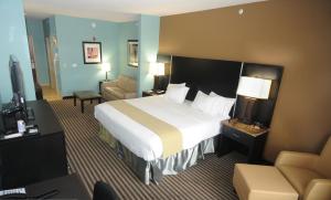 a hotel room with a bed and a living room at Holiday Inn Express Somerset by IHG in Somerset +21 photos