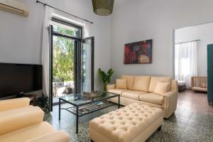 a living room with two couches and a tv at Villa Eleonora di Rodi in Rhodes Town