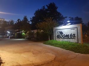 a sign for a house with a street at night at Room62 in Wat Pa