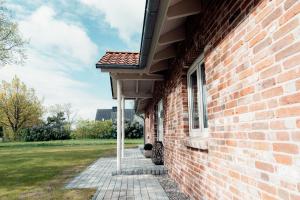a brick building with awning on the side of it at Ferienhaus Loheide - mit Sauna in Langenhorn