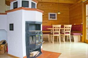 estufa de leña en una habitación con mesa y sillas en Appartement Fichte, en Ramsau am Dachstein