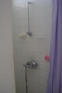 a shower in a bathroom with a shower curtain at ESCALE CREOLE in Terre-de-Haut