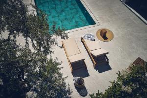 an overhead view of chairs and a swimming pool at Cielo Luxury Villas in Zakynthos Town