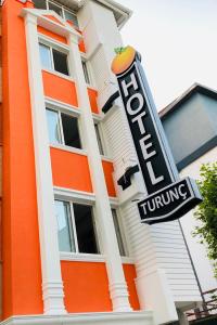 a hotel turning sign in front of a building at Turunç Hotel ANTALYA in Antalya