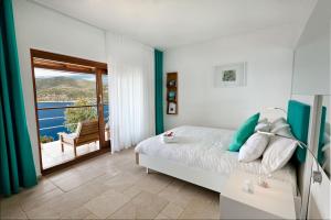 a bedroom with a bed and a balcony at Hotel Villa Mahal in Kalkan