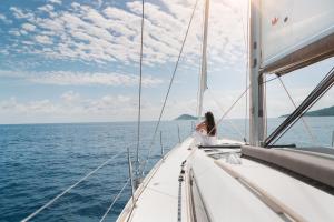 a woman sitting on a sailboat in the ocean at Hotel Villa Mahal in Kalkan