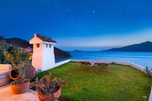a backyard with a small house with a view of the ocean at Hotel Villa Mahal in Kalkan