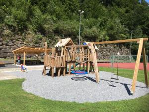 a park with a playground with a swing set at Ferienwohnung ob Vierwaldsättersee in Isenthal