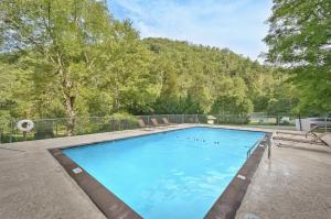 a large blue swimming pool in a yard at His Promises Cabin in Pigeon Forge