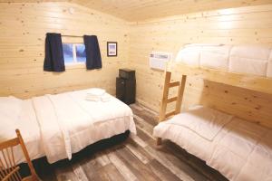 a bedroom with two bunk beds and a ladder at Firehouse Campground in Hill City
