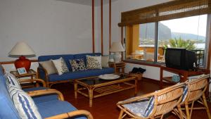 salon z niebieską kanapą i telewizorem w obiekcie La Casa Grande w mieście Valle Gran Rey