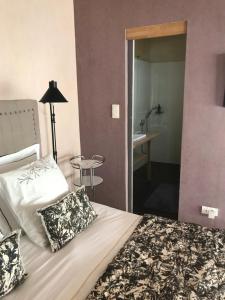 Cama ou camas em um quarto em Les Chambres de l'Abbaye