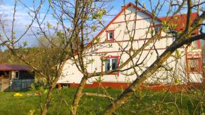 a large white house with a red roof at Organistowka in Bircza