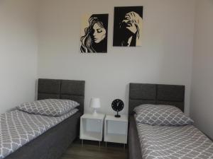 two beds sitting next to each other in a bedroom at Kwatery prywatne Lotnicza in Bielsko-Biała