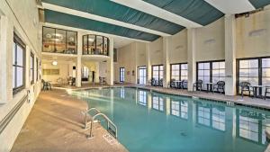 a large swimming pool with blue water in a building at Lifes a beach on Myrtle Beach in Myrtle Beach