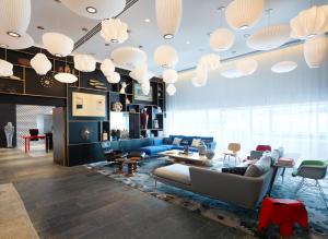 a living room filled with furniture and a tv at citizenM Paris Gare de Lyon in Paris
