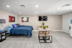 a bedroom with a bed and a tv on the wall at Cosmic Studio at North Downtown in Houston