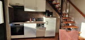 a small kitchen with a sink and a stove at Haus am Koiteich in Plau am See